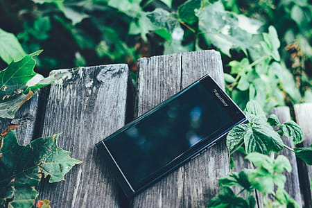 Black Blackberry Priv Smartphone on Brown Board thumbnail