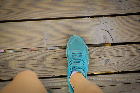 person wearing teal running shoe thumbnail