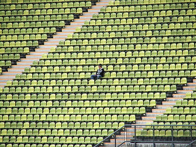 Woman in Grey Shirt Sitting on Stadium Chair thumbnail
