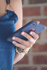 woman holding iPhone with blue case thumbnail
