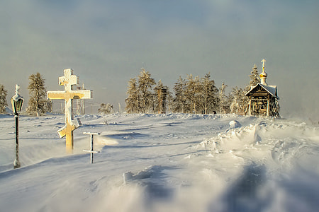 beige house and cross near trees during winter thumbnail