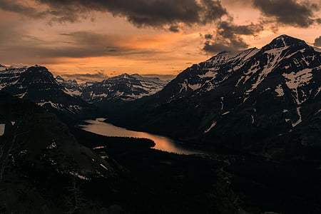 body of water in between mountains thumbnail