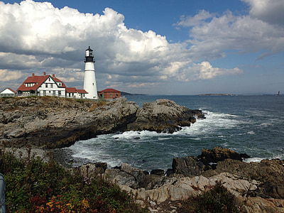 white lighthouse near body of water during daytime thumbnail
