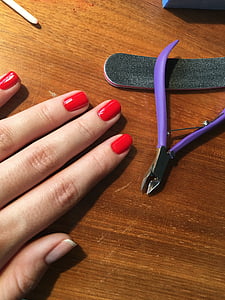person's hand beside purple nail nipper thumbnail