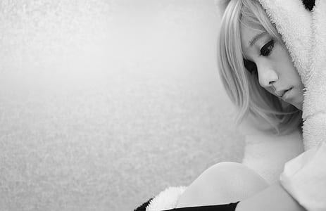 woman in fur coat sitting by the wall thumbnail