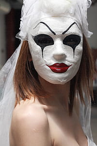 woman wearing face mask while taking selfie thumbnail