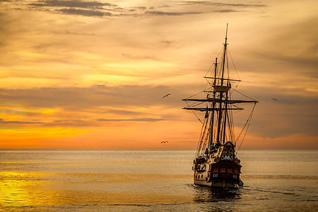 Brown Sailing Boat on the Sea during Sunset thumbnail