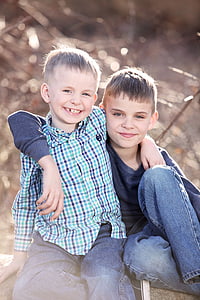 two boys looking at the camera during daytime thumbnail