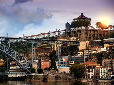 dome building on top of hill with metal bridge near body of water thumbnail