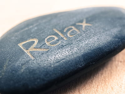 closeup photo of blue stone with relax text engraved thumbnail