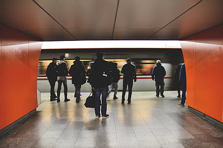 group of people walking near moving train thumbnail