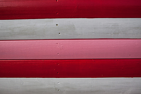 Close-up shot of red, white and pink-coloured wood panels. Image captured in Whitstable, Kent, England thumbnail