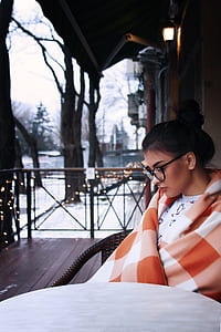 woman sitting on armchair beside table thumbnail