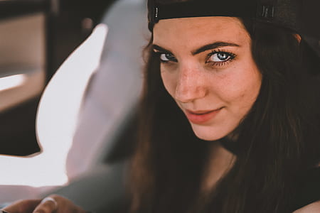selective focus photography of woman in black cap thumbnail