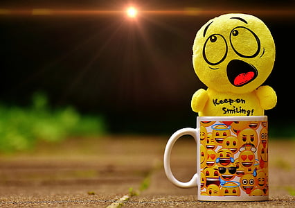yellow emoji keep on smiling plush toy on emoji print white ceramic mug thumbnail
