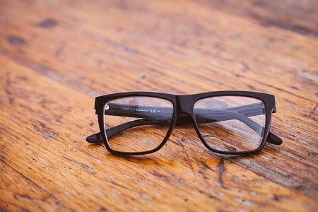 black framed eyeglasses on brown surface thumbnail