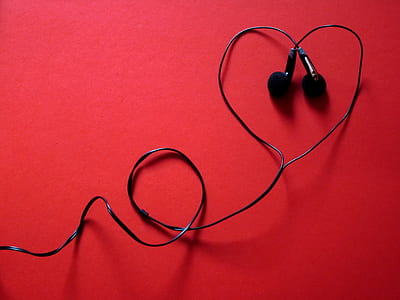 black corded earphones on red surface thumbnail