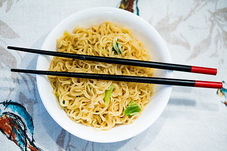 noodles in white ceramic bowl and black chopsticks thumbnail
