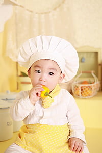 selective focus photography of boy in chef costume thumbnail