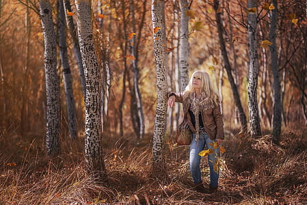 woman standing beside tree thumbnail