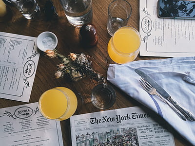 closeup photo of two drinking glasses filled with yellow beverage thumbnail