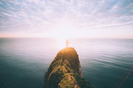 person standing on top of cliff thumbnail