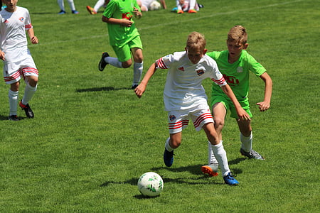 children playing soccer during daytime thumbnail