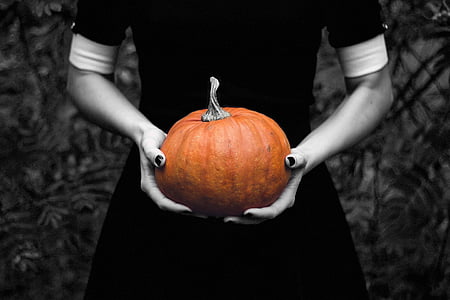 selective color photography of person holding pumpkin thumbnail