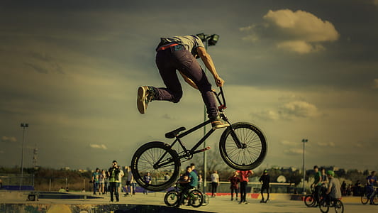 black flipping BMX bike in air thumbnail
