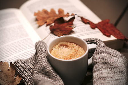 white ceramic coffee mug beside a open book thumbnail
