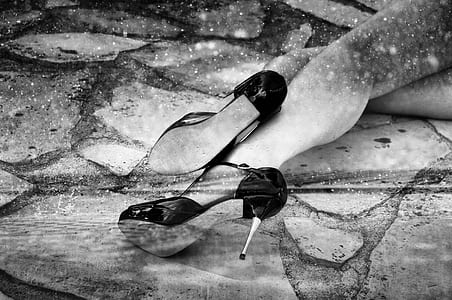 woman wearing black stilettos laying on concrete surface thumbnail