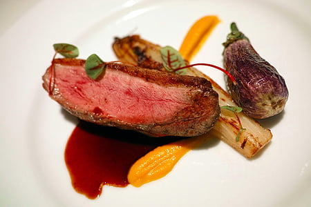 steak with spinach, eggplant, and sauce on plate thumbnail