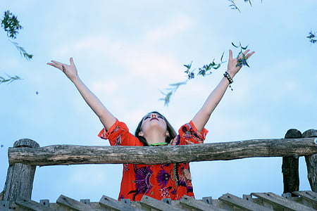 woman raising arms in the air during daytime thumbnail