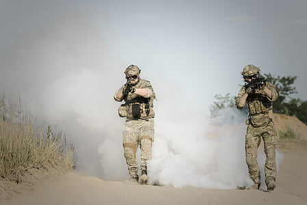 soldier fires rifle during daytime thumbnail
