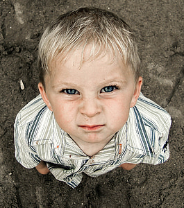 boy wearing plaid collared shirt staring above during daytime thumbnail