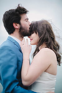 man kissing woman's forehead thumbnail