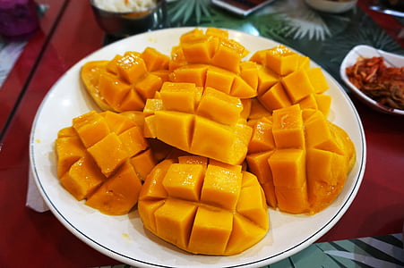 sliced of mango serve on white plate thumbnail