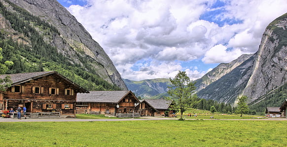 several wooden houses near mountains thumbnail
