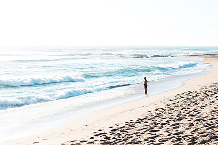 person standing in front of body of water thumbnail
