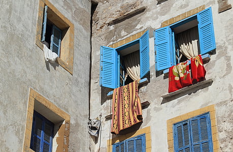 brown and red textiles hanging from windows thumbnail