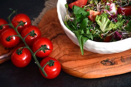 tomatoes beside bowl of vegetable salad thumbnail