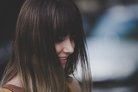 woman in brown shirt smiling thumbnail