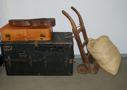 brown sack beside hand truck and storage boxes thumbnail