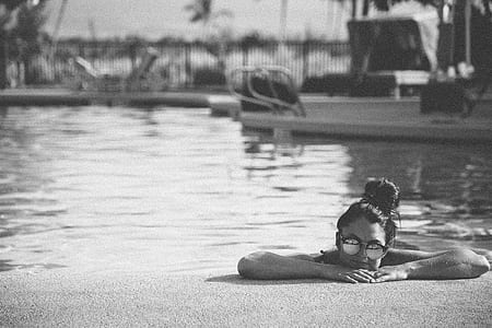 women in body of water grayscale photography thumbnail