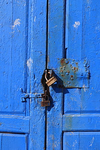 two brass-colored padlocks on blue wooden doors thumbnail