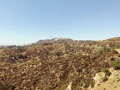 in distant brown mountain under blue sky thumbnail