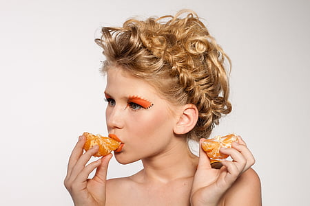 woman eats orange citrus fruit thumbnail