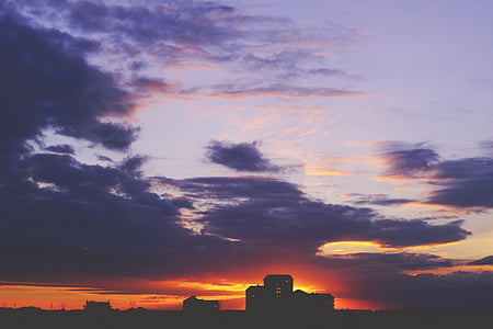 silhouette of city buildings under cloudy sky thumbnail