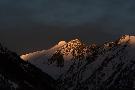snow covered mountain during night time thumbnail
