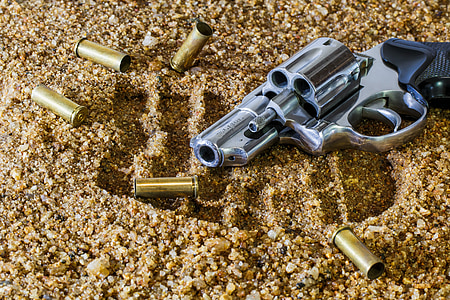 chrome revolver pistol on brown sands thumbnail